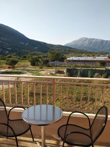a table and chairs on a balcony with a view at Kalias Hotel in Vasiliki