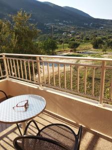 a table and two chairs on a balcony with a table at Kalias Hotel in Vasiliki