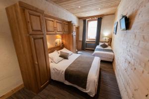 a bedroom with a bed and a dresser at La Pointe Percée in Le Grand-Bornand