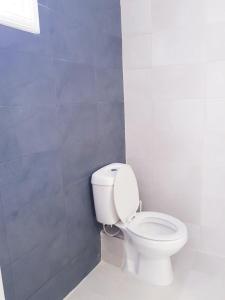 a bathroom with a white toilet in a room at Konstantinos-Elli Rooms in Nea Vrasna