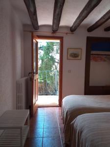 a bedroom with two beds and a sliding glass door at Casa Rural Boletas in Loporzano