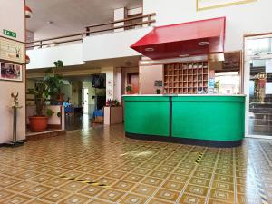 a restaurant with a green counter in a building at Hotel Santa Maria Del Bagno in Pesche