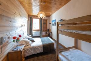 a bedroom with two bunk beds in a room at La Pointe Percée in Le Grand-Bornand
