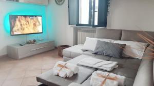 a living room with a couch and a flat screen tv at Villa Mimma in Taormina