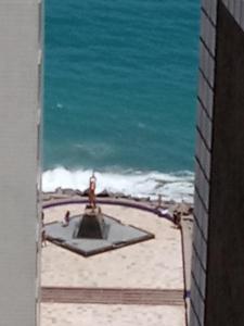 a view of the beach with a fountain in the sand at Residencial Porto de Iracema in Fortaleza