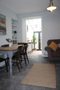 a living room with a table and chairs and a couch at Karensa in Newlyn
