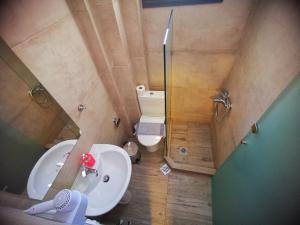 a small bathroom with a sink and a toilet at Sarti Holidays in Sarti +19 photos