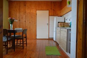 a kitchen with a table and a refrigerator at Dom na Mazurach in Ostróda