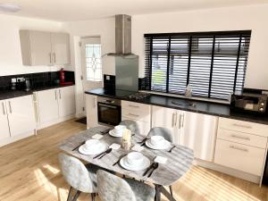 a kitchen with a table and chairs in it at Annexe@No8 in Haverfordwest