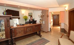 a woman sitting at a desk with a laptop at Ca' Dei Leoni in Venice