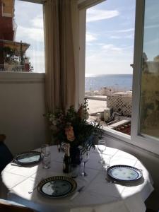 a table with a view of the ocean from a window at La Casetta e Mammà in Positano