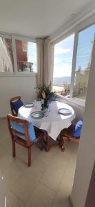 a dining room with a table and a large window at La Casetta e Mammà in Positano