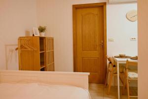 a bedroom with a bed and a table and a door at Apartment Marjo in Piran