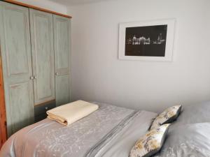 a bedroom with a bed and a cabinet at Apartament Sobieski in Sanok
