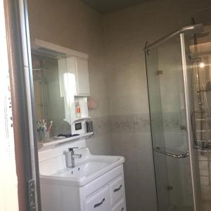 a bathroom with a sink and a shower at Warm Flat in Gonio +33 photos