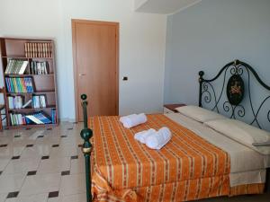 a bedroom with a bed with two towels on it at Grand Hostel Calabria in Pietrapaola