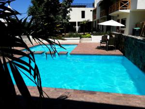 a swimming pool with blue water in front of a building at Hotel Sierra Linda in Xilitla