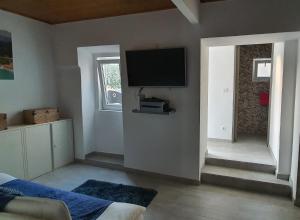 a living room with a flat screen tv on the wall at Vila Azul in Sesimbra