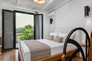 a bedroom with a bed and a large window at Kamares Sanctuaries in Kolymvari