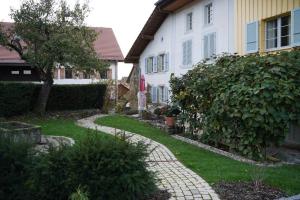 a house with a walkway in front of a yard at Appartement Claude in Châtillon