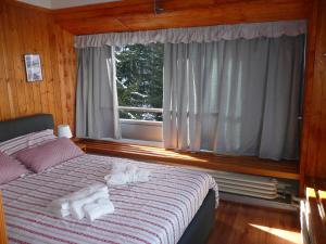 a bedroom with a bed with towels on it at Appartamento Sole Alto in Marilleva