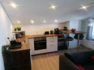eine Küche mit weißen Schränken und einer Arbeitsplatte in der Unterkunft Haus Monteiro in Elbigenalp