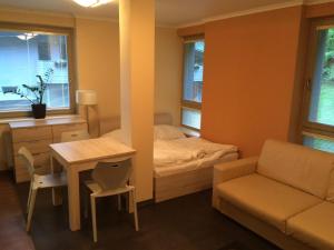 a small room with a bed and a table and a couch at Apartman Harrachov in Harrachov