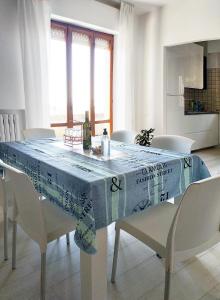 a dining room table with a blue and white table cloth at CONERO APARTMENT in Castelfidardo