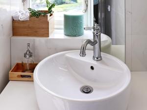 a white sink in a bathroom with a window at 4 person holiday home in Veddige in Veddige