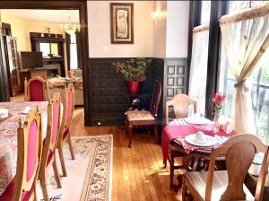 a dining room with a red table and chairs at Redwood Bed and Breakfast in Niagara Falls