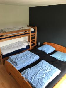 a room with three bunk beds in it at Holiday home Als in Augustenborg