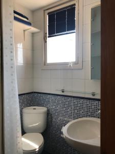 a bathroom with a toilet and a sink and a tub at Atiko 15 in Gijón +17 photos