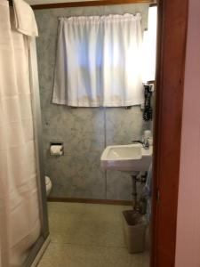 a bathroom with a sink and a toilet and a window at Marcotte Motor Court in Old Orchard Beach