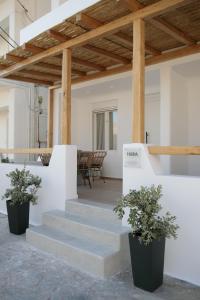 a staircase with two potted plants in a room at Hora Seaside Suites in Naxos Chora