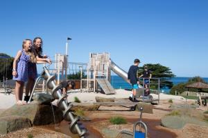 a group of people standing in a playground at BIG4 Apollo Bay Pisces Holiday Park in Apollo Bay