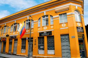 an orange building on the corner of a street at Casabella Hotel in Manizales