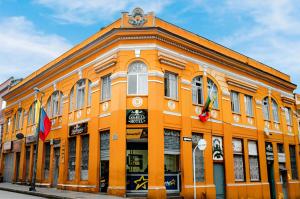 an orange building with a clock on top of it at Casabella Hotel in Manizales