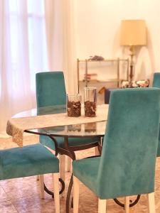 a wooden table with two chairs and two glasses on it at Hostal Orleans in Barcelona