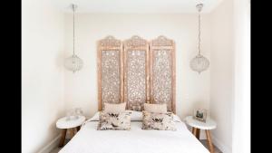 a bedroom with a bed with two tables and two lamps at Casa Yandiola in Castro-Urdiales