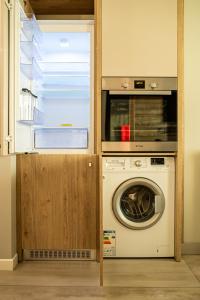 a kitchen with a washer and dryer in a room at BLISS Apartment in Constanţa