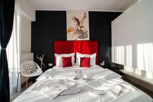 a bedroom with a large bed with a red headboard at BLISS Apartment in Constanţa
