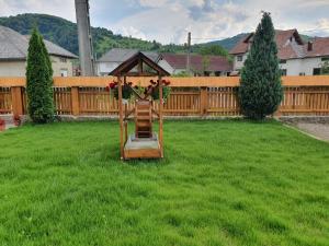 a garden with a gazebo in the grass at Casa Alexandru – Locul în care te simți acasă in Vişeu de Jos