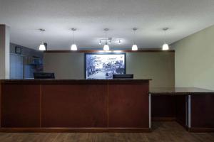 an office with a bar with a tv on the wall at Super 8 by Wyndham Cromwell/Middletown in Cromwell