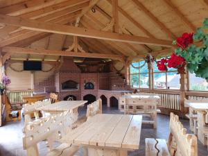 a large room with a wooden table and a fireplace at Casa Alexandru – Locul în care te simți acasă in Vişeu de Jos