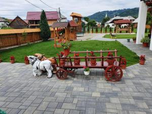a couple of dogs pulling a red wagon at Casa Alexandru – Locul în care te simți acasă in Vişeu de Jos