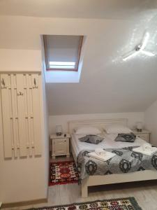 a small bedroom with a bed and a window at Casa Alexandru – Locul în care te simți acasă in Vişeu de Jos