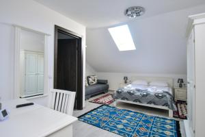 a bedroom with a bed and a living room at Casa Alexandru – Locul în care te simți acasă in Vişeu de Jos