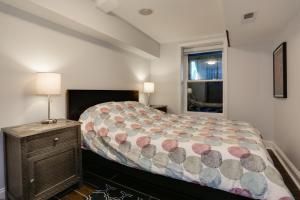 a bedroom with a large bed and a window at English Basement Suite in Petworth, Washington, DC -- FREE off-street parking, walk to Metro and restaurants in Washington, D.C.
