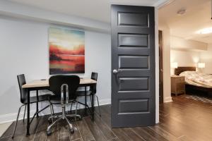 a room with a desk and chairs and a bed at English Basement Suite in Petworth, Washington, DC -- FREE off-street parking, walk to Metro and restaurants in Washington