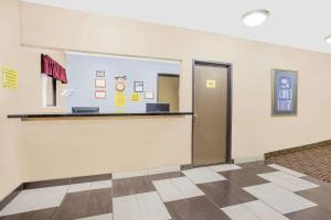 an empty room with a door and a counter at Boarders Inn & Suites by Cobblestone Hotels Waterloo Cedar Falls in Waterloo